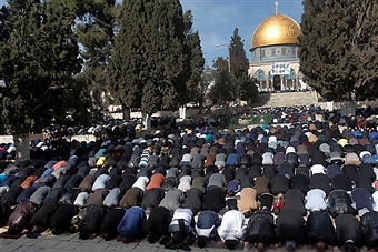 Palestinian worshippers pray outside Al Aqsa Mosque